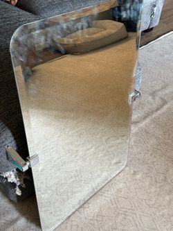 Frameless mirror with wall brackets