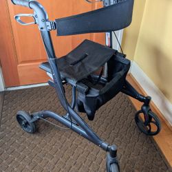 Guardian Walker with hand brakes, seat, padded back, and bag.