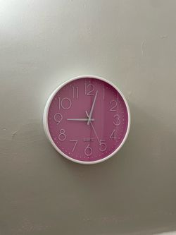 Clock. Wall. Pink and white.