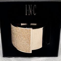 This I-N-C International Concepts hinged cuff bracelet features a textured, rose
