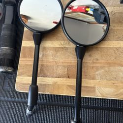 Motorcycle mirrors, two sets of hand grips, and barn weights. All items brand new.
