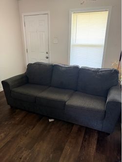 Comfortable gray sofa in good condition. Plus love seat