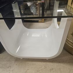 white and glass accent table features a unique U-shaped modern base.