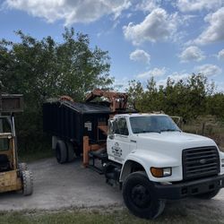 Grapple Truck And Bobcat 
