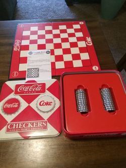 Vintage coca cola checker board game with bottle cap checkers and original instruction booklet and Tin metal case like new located in palm springs ca 