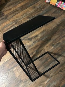 black metal C-shaped side table