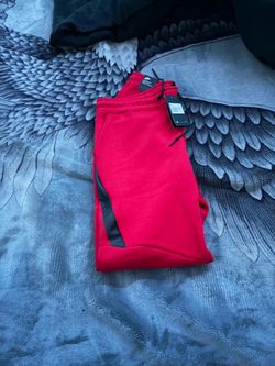 Red Nike tech sweatpants