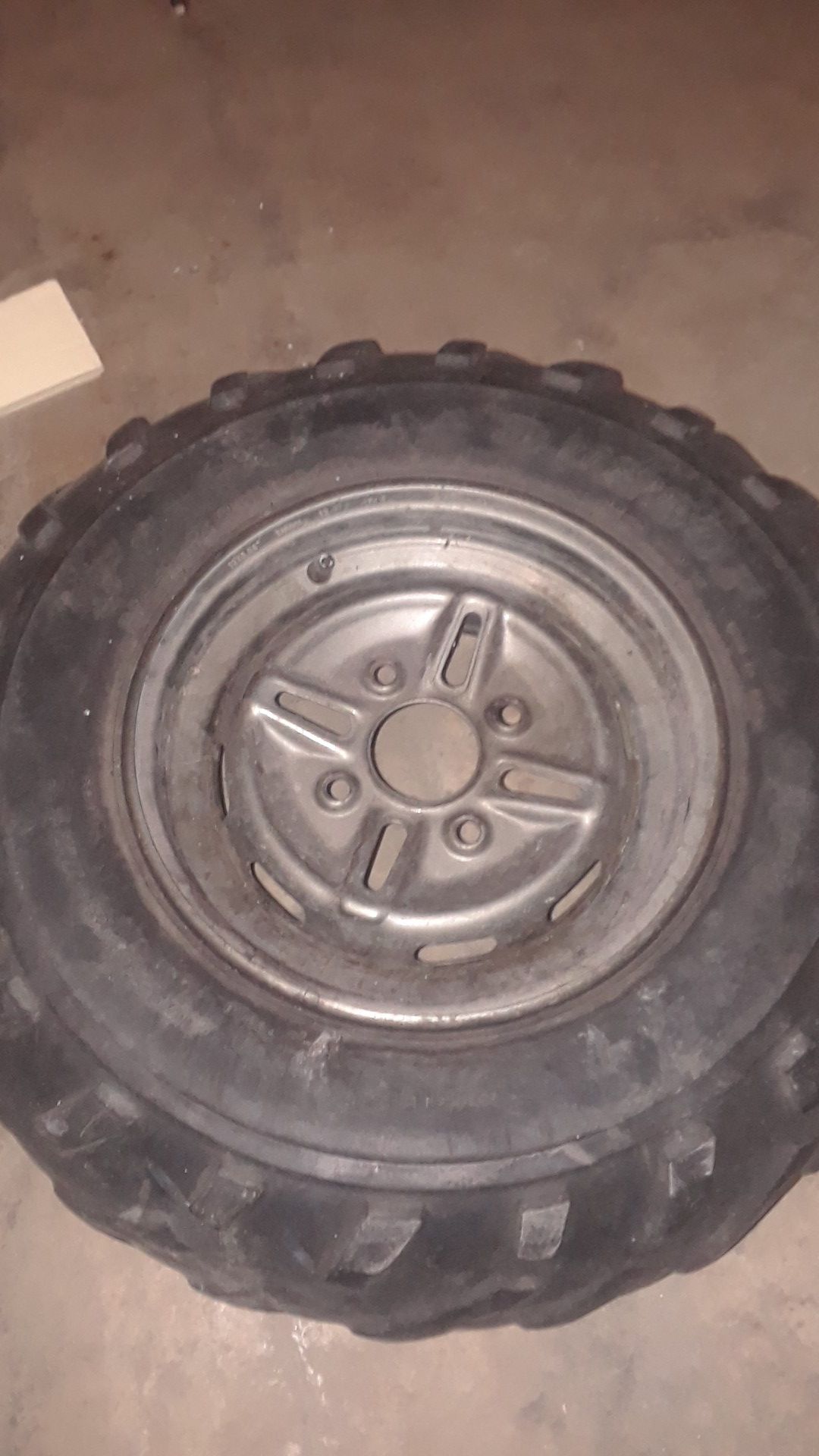 Photo Used front yamaha 4 wheeler rim 12.97 4vw 4 lug. With tire on it holds air