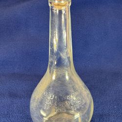 Vintage glass bottle, likely used for liquor, featuring a distinctive pear shape