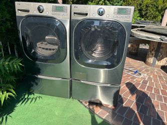 Lg front load washer and gas dryer on pedestals