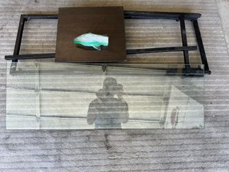 Glass top desk with black shelf
