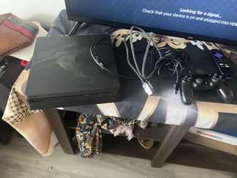 PS4 with two controllers and game