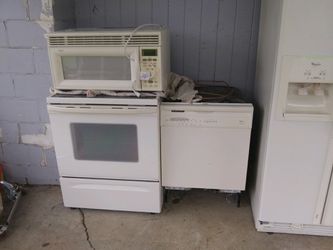 Whirlpool appliances. Electric range. Microwave. Double door refrigerator with ice and water and dishwasher.