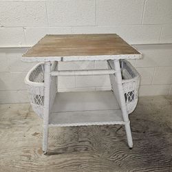Vintage White wicker side table w/ magazine racks and a wood plank top. 