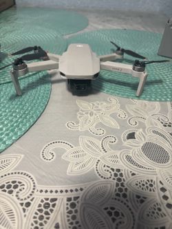 Drone DJI Mini 2 with the DJI remote controller and 3-battery charging hub