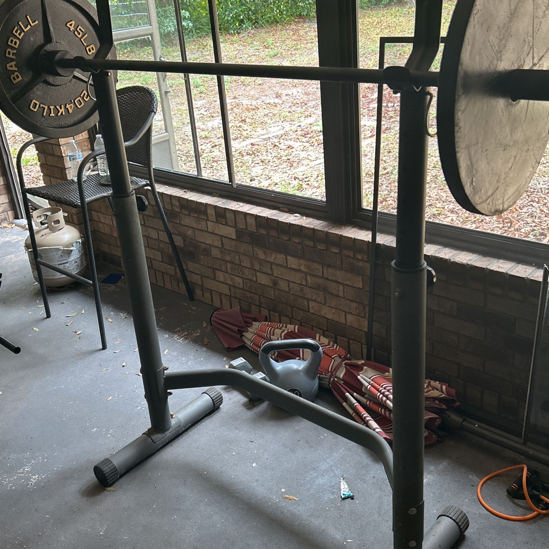 Squat rack, Bench press with preacher curls, and leg extension machine with hamstrings curls