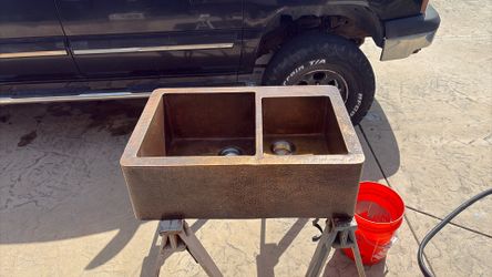 This is a used Premier Copper Products hammered double-basin farmhouse apron sink.