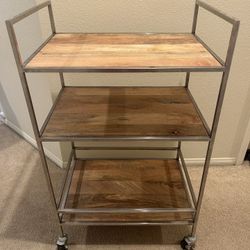 Vintage bar cart with solid wood shelves and brushed steel frame