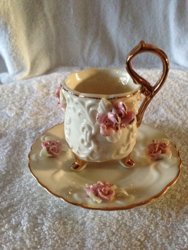 Beautiful teacup and saucer with raised flowers and gold edging. Made in China.