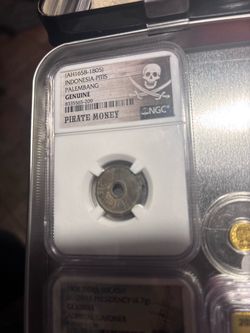 Genuine pirate money authenticated by a premier grading company.
