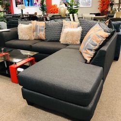 Grey Sectional With Accent Pillows.