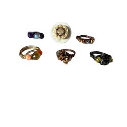 Six wire beaded rings, ranging from 3.5-7 in size, colors in shades of ivory, browns, bronze, orange, black, purple
