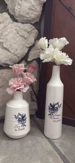 A pair of vases and artificial flowers