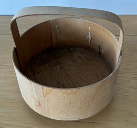 Circular wood basket with handle. 7” diameterX6” tall with feet.
