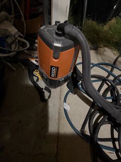 Rigid corded backpack vaccum