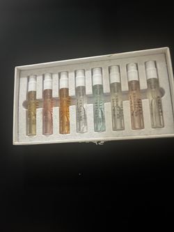 Diverse collection of eight LASTAR perfume sample vials in a white presentation box. This set includes various scents such as Monet Garden, Cool Town,