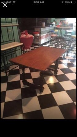 Solid oak antique table with casters very nice