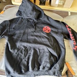 Naruto Shippuden pullover hoodie featuring a graphic of Sasuke Uchiha on the back