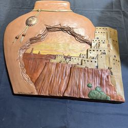 This piece is a vintage hand-painted folk art depicting a Native American adobe scene