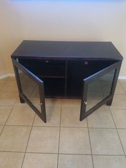 Dark wood stand with double glass doors