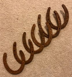 Set of 6 primitive rustic cast iron horseshoes