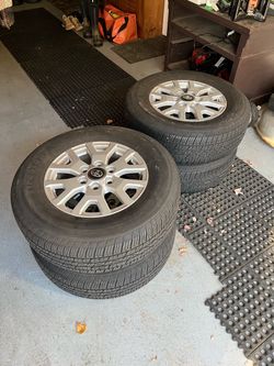 OEM Toyota Tacoma rims with Firestone tires.