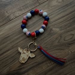 red, white, and blue cow wristlet 