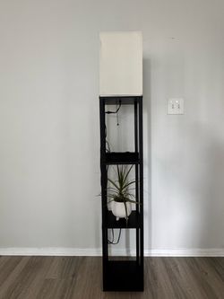 Black floor lamp with shelves and white shade