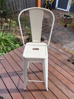 White outdoor metal bar stool.