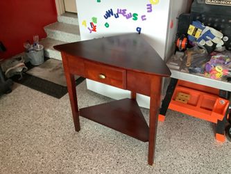 Trenton solid wood end table with drawer triangle shape approximately 31” tall, 29” across No cracks or scratches, some discoloration from a doily in 