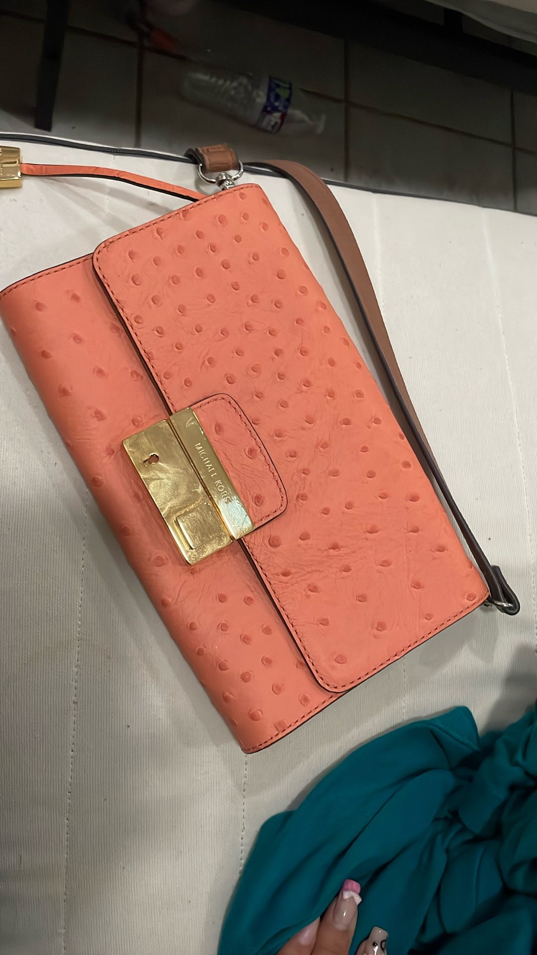 Michael Kors Ava clutch bag with an ostrich-embossed leather finish