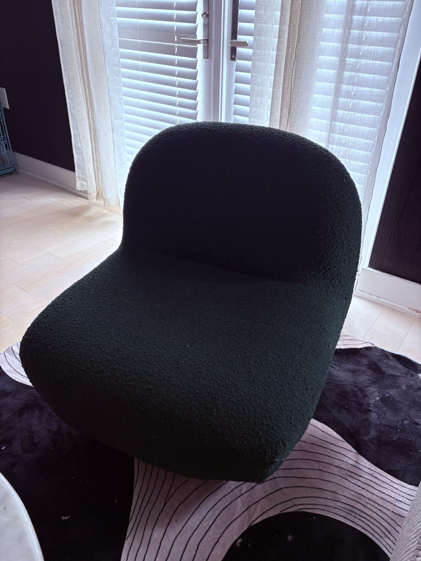 green boucle accent chair with a gold swivel base