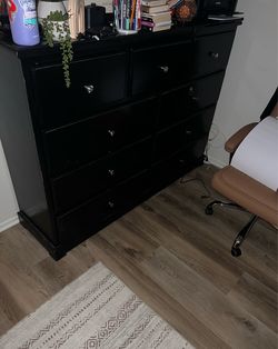 Black wood dresser - 9 drawers. About 5ft tall.