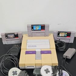 Nintendo SNES console with 2 controllers, power cable, and 3 games: Super Mario World, Super Mario All-Stars, and Jeopardy Deluxe Edition SEND ME OFF.