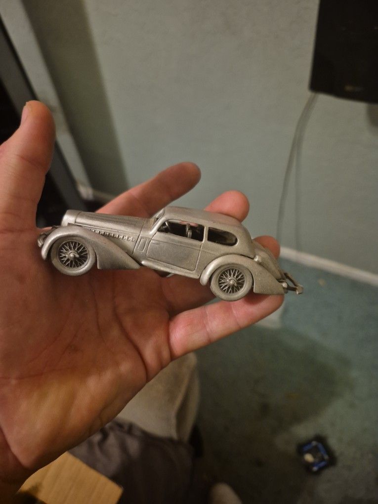 Vintage  pewter model car, likely a 1930s-era Delahaye 135M coupe.