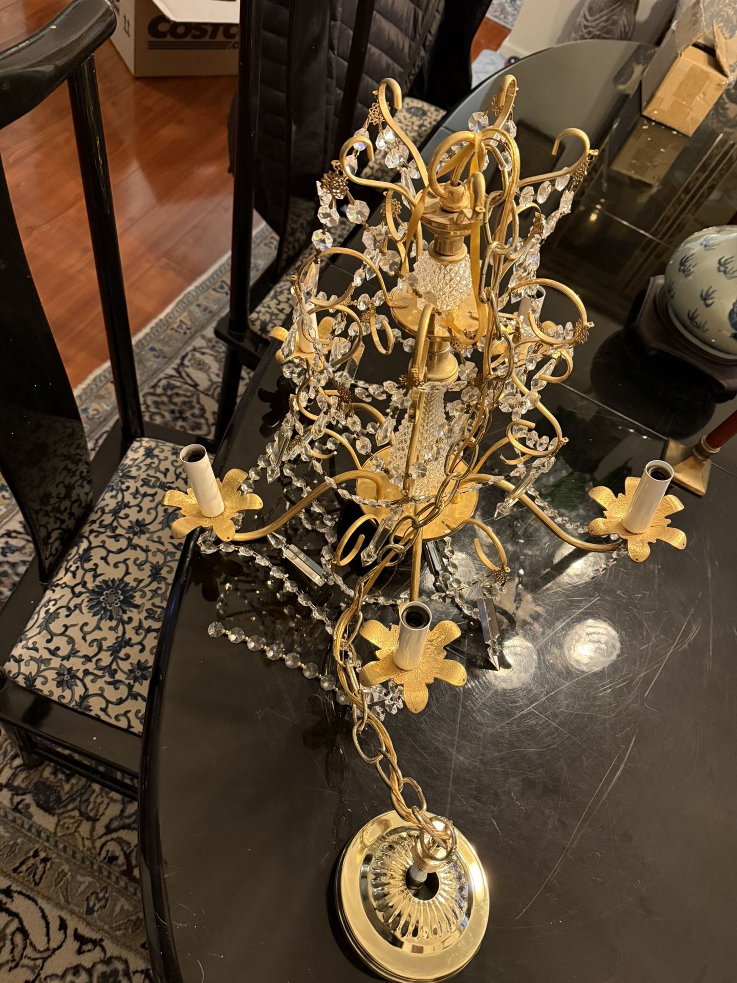 This exquisite antique chandelier, crafted from crystal or glass, boasts a captivating five-light design. Its diameter measures approximately 17 inche