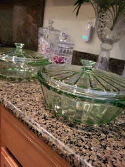 Casserole dishes set up two glass lids. Bottoms, everything's perfect never been used. The two piece set