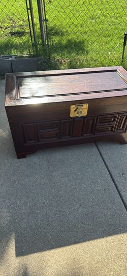 Wooden Storage Chest With Decorative Details, And Brass Handles
