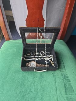 Jewelry box with pendants, watch, and rings