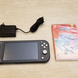 Gray Nintendo Switch Lite With Charger And Monopoly/Risk/Trivial Pursuit $129